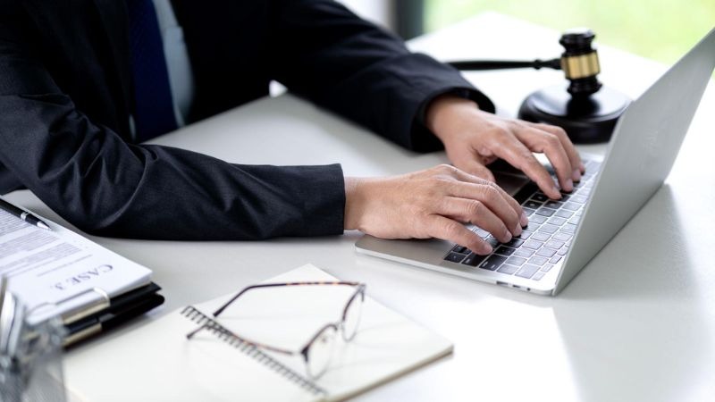 on-page seo for lawyers analyzing website performance on laptop in law firm office