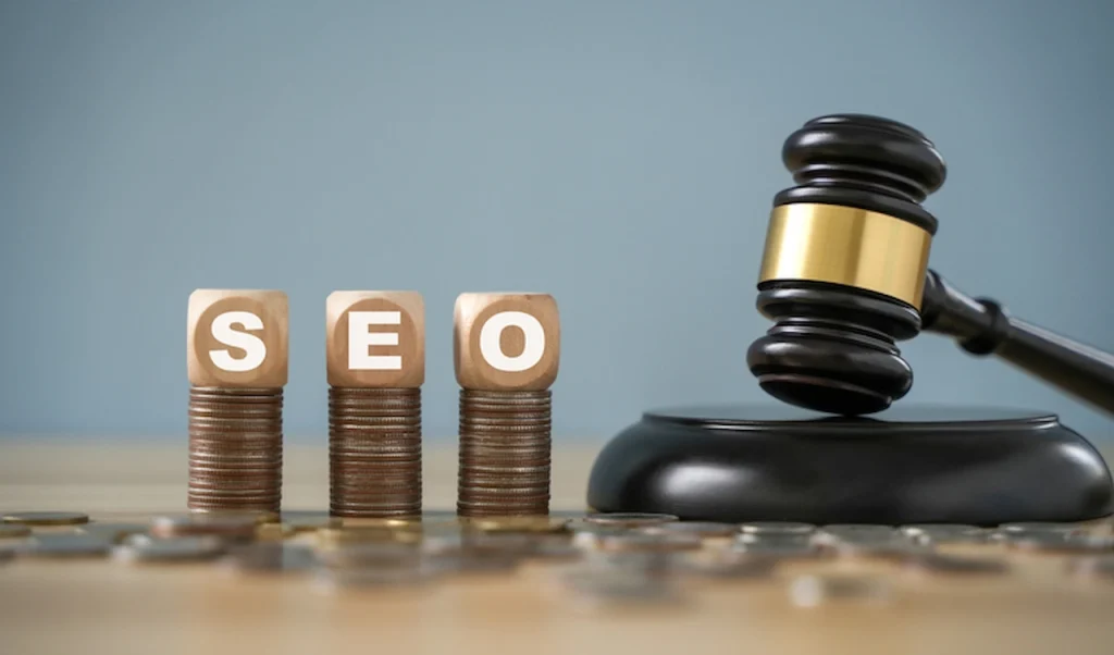 Judge's gavel beside SEO blocks stacked on coins representing long-term law firm SEO investment